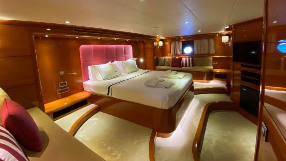 Luxurious cabin with double bed, windows, and elegant lighting